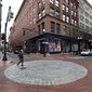 In this Wednesday, May 6, 2020, photo, a passerby walks through an intersection in the downtown section of Providence, R.I., as many people remain at home due to the coronavirus. Much of New England is slowly emerging from a six-week lockdown, with greenhouses, golf courses and barber shops rolling out the welcome mat for customers anxious to return to some sense of normalcy. (AP Photo/Steven Senne)