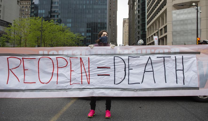 Counter protestors with &quot;Refuse Fascism&quot; block off Market Street as demonstrators in support of &quot;Open Up Philly&quot; circle City Hall in their cars Friday, May 8, 2020, in Philadelphia, Pa.  (Joe Lamberti/Camden Courier-Post via AP) ** FILE **