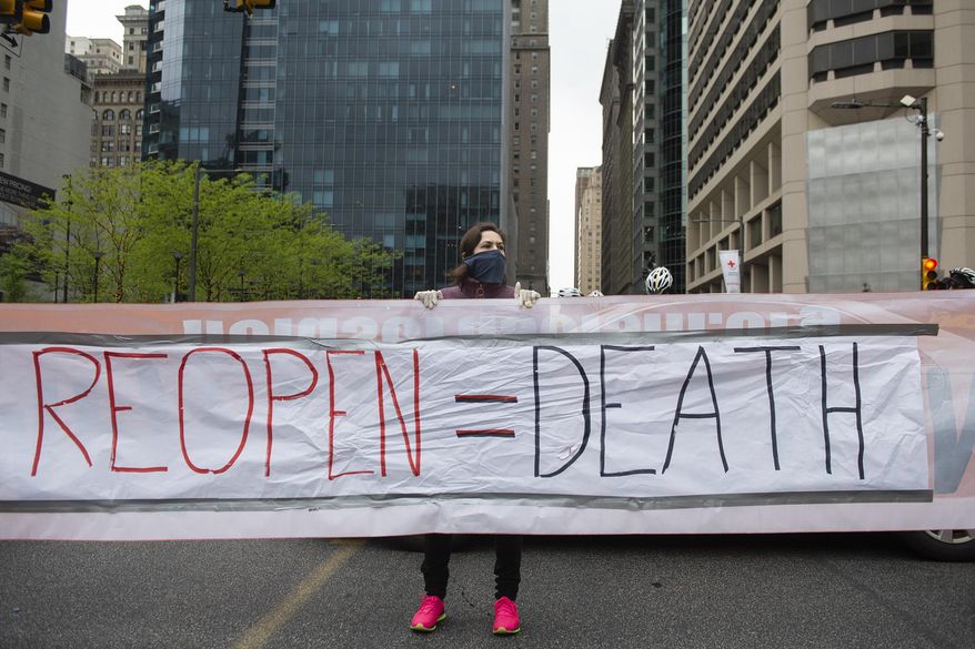 Counter protestors with "Refuse Fascism" block off Market Street as demonstrators in support of "Open Up Philly" circle City Hall in their cars Friday, May 8, 2020, in Philadelphia, Pa. (Joe Lamberti/Camden Courier-Post via AP) ** FILE **