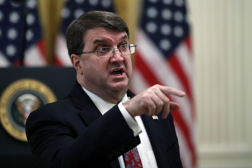 Veterans Affairs Secretary Robert Wilkie talks before President Donald Trump arrives to speak about protecting seniors, in the East Room of the White House, Thursday, April 30, 2020, in Washington. (AP Photo/Alex Brandon)