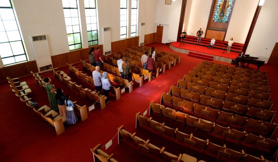 Using social distancing practices, churchgoers return to in-person services at Alamo Heights Baptist Church, Sunday, May 10, 2020, in San Antonio. Texas&#x27; stay-at-home orders due to the COVID-19 pandemic have expired and Texas Gov. Greg Abbott has eased restrictions on many businesses, state parks, churches and places of worship. (AP Photo/Eric Gay)