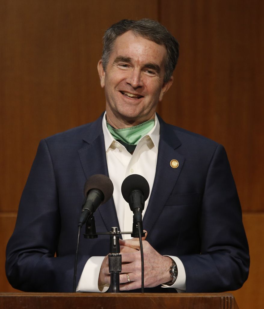 Virginia Governor Ralph Northam smiles as he gives updates on the Coronavirus during his press briefing inside the Patrick Henry Building in Richmond, Va., Monday, May 11, 2020. (Bob Brown/Richmond Times-Dispatch via AP)