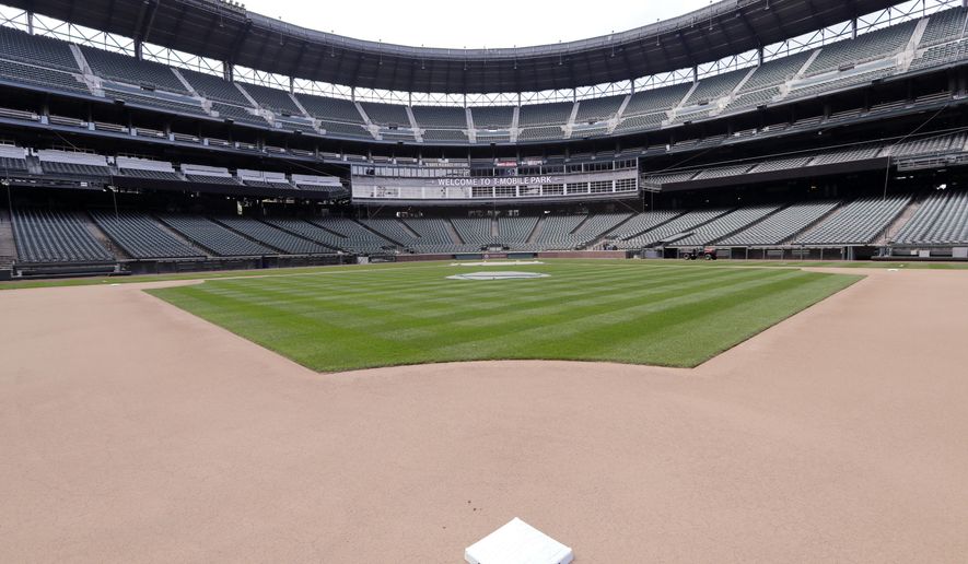 Second base sits in its place in an otherwise empty ballpark where grounds crew members continue to keep the Seattle Mariners' field in playing shape as the ballpark goes into its seventh week without baseball played because of the coronavirus outbreak Monday, May 11, 2020, in Seattle. (AP Photo/Elaine Thompson) **FILE**