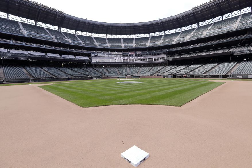 Second base sits in its place in an otherwise empty ballpark where grounds crew members continue to keep the Seattle Mariners' field in playing shape as the ballpark goes into its seventh week without baseball played because of the coronavirus outbreak Monday, May 11, 2020, in Seattle. (AP Photo/Elaine Thompson) **FILE**