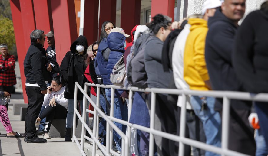 In this March 17, 2020, file photo, people wait in line for help with unemployment benefits at the One-Stop Career Center in Las Vegas, Nevada.  On May 21, the State of Tennessee reported that it reached its highest monthly unemployment rate ever in the month of April due to coronavirus-related job losses.  (AP Photo/John Locher, File) **FILE**