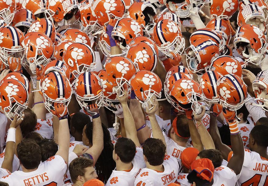 FILE - In this Jan. 7, 2019, file photo, Clemson players huddle before the NCAA college football playoff championship game against Alabama in Santa Clara, Calif. Clemson's most recent national championship football team also met the mark in the classroom. On Tuesday, May 12, 2020, the Tigers' 2018 football team was one of 10 national champs to earn recognition from the NCAA for their Academic Progress Rate scores. (AP Photo/Jeff Chiu, File)