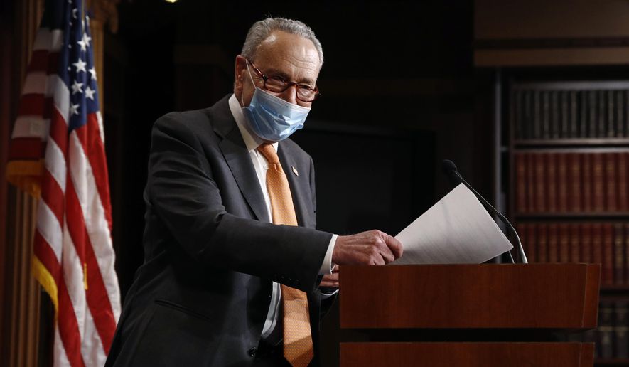 Senate Minority Leader Sen. Chuck Schumer of N.Y., center, arrives for a news conference on Capitol Hill in Washington, Tuesday, May 12, 2020. (AP Photo/Patrick Semansky)