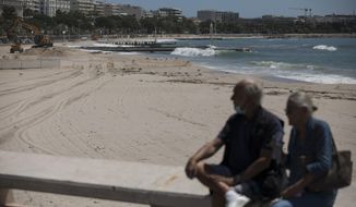 The deserted Croisette beach is pictured empty due to measures put in place to stop the spread of the coronavirus in Cannes, southern France, Tuesday, May 12, 2020.  The Cannes Film Festival won&#39;t kick off as planned on Tuesday. The festival&#39;s 73rd edition has been postponed indefinitely, part of the worldwide shutdowns meant to stop the spread of the coronavirus. (AP Photo/Daniel Cole)
