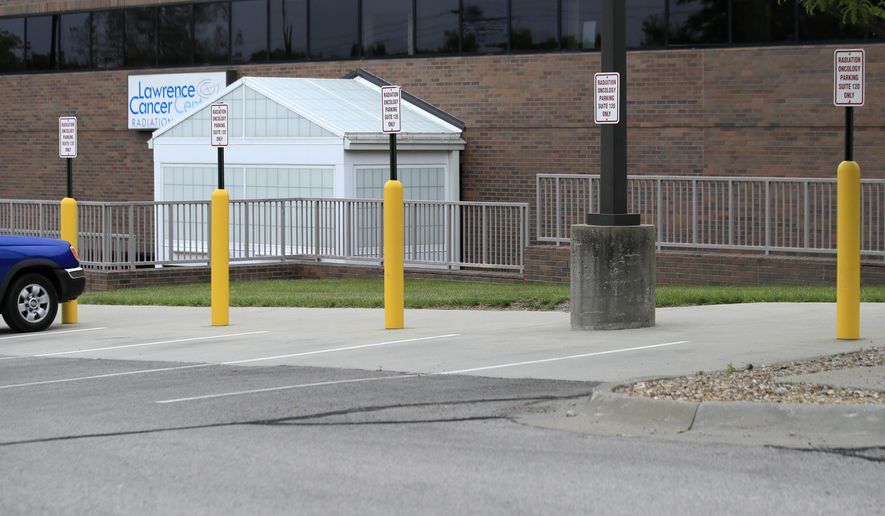 Parking is available outside the Lawrence Cancer Center at Lawrence Memorial Hospital in Lawrence, Kan., Tuesday, May 12, 2020. Kansas legislators are considering proposals to prevent medical providers from being sued if they put off non-emergency care to handle coronavirus patients. (AP Photo/Orlin Wagner)