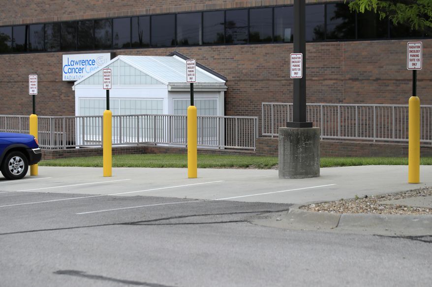 Parking is available outside the Lawrence Cancer Center at Lawrence Memorial Hospital in Lawrence, Kan., Tuesday, May 12, 2020. Kansas legislators are considering proposals to prevent medical providers from being sued if they put off non-emergency care to handle coronavirus patients. (AP Photo/Orlin Wagner)