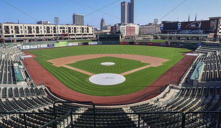 In this April 8, 2020, file photo, an empty Parkview Field minor league baseball stadium is shown in downtown Fort Wayne, Ind. Unlike the NFL, NBA or Major League Baseball that can run on television revenue, it's impossible for some minor sports leagues in North America to go on in empty stadiums and arenas in light of the coronavirus pandemic. These attendance-driven leagues might not play again at all in 2020, putting some teams in danger of surviving at all and potentially changing the landscape of minor league sports in the future. (Mike Moore/The Journal-Gazette via AP) ** FILE **