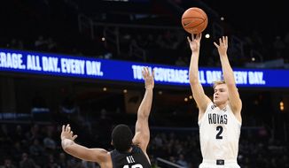  In this Tuesday, Jan. 28, 2020, file photo, Georgetown guard Mac McClung (2) shoots as he is defended by Butler forward Bryce Nze (10) during the second half of an NCAA college basketball game, in Washington. McClung announced Wednesday, May 13, 2020, that he plans to enter the NCAA transfer portal so he can switch schools after taking his name out of consideration for the NBA draft. (AP Photo/Nick Wass, File)  **FILE**