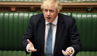 In this handout photo provided by UK Parliament, Britain&#39;s Prime Minister Boris Johnson speaks during Prime Minister&#39;s Questions in the House of Commons, London, Wednesday, May 13, 2020. (Jessica Taylor/UK Parliament via AP)