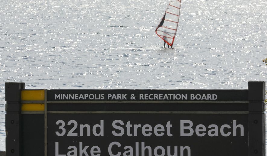 FILE - In this May 2, 2017 file photo, a windsurfer glides on the surface of Lake Calhoun in Minneapolis. A divided Minnesota Supreme Court said Wednesday, May 12, 2020, that the state Department of Natural Resources has the authority to change the name of a popular lake, Lake Calhoun, back to its original Dakota name, Bde Maka Ska. (Jeff Wheeler/Star Tribune via AP, File)