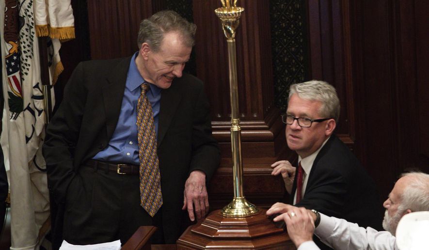 FILE - In this May 30, 2019, file photo, Democratic Speaker of the House Michael J. Madigan, left, and House Republican Leader Jim Durkin talk at the State Capitol in Springfield, Ill. The Illinois House will convene in Springfield for three days next week to take up a spring-session workload long delayed by the coronavirus pandemic. A letter from Madigan to the House minority leader on Wednesday, May 13, 2020, sets the session for May 20-22 with extraordinary measures to prevent the spread of the highly contagious and potentially lethal coronavirus. They include pre-session testing of all legislators for COVID-19. (Zbigniew Bzdak/Chicago Tribune via AP)