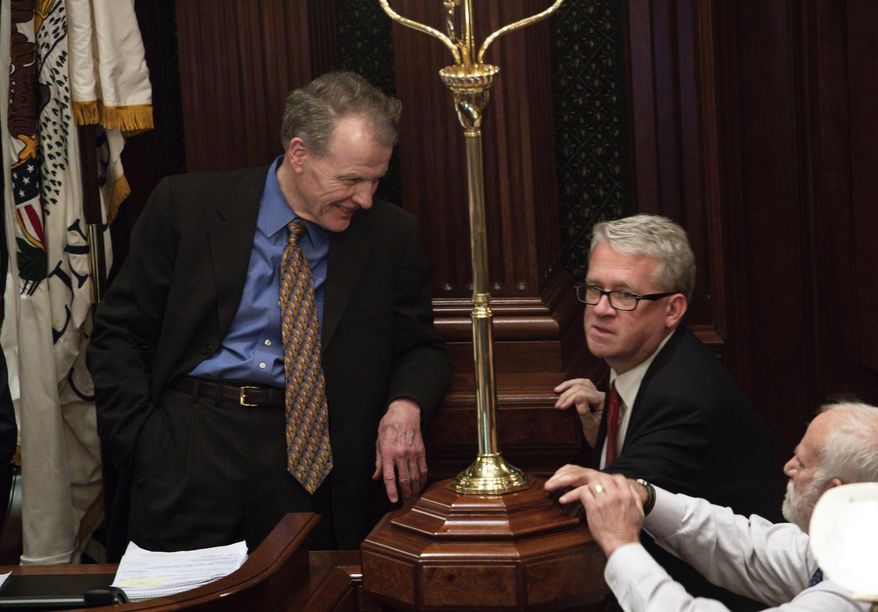 FILE - In this May 30, 2019, file photo, Democratic Speaker of the House Michael J. Madigan, left, and House Republican Leader Jim Durkin talk at the State Capitol in Springfield, Ill. The Illinois House will convene in Springfield for three days next week to take up a spring-session workload long delayed by the coronavirus pandemic. A letter from Madigan to the House minority leader on Wednesday, May 13, 2020, sets the session for May 20-22 with extraordinary measures to prevent the spread of the highly contagious and potentially lethal coronavirus. They include pre-session testing of all legislators for COVID-19. (Zbigniew Bzdak/Chicago Tribune via AP)