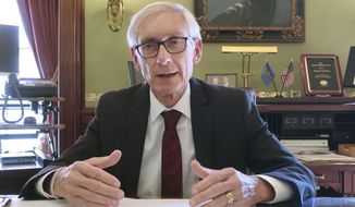 FILE - In this Dec. 4, 2019 file photo, Wisconsin Gov. Tony Evers speaks during an interview with The Associated Press in his Statehouse office in Madison, Wis. Evers&#39; administration overstepped its authority when it unilaterally extended the governor&#39;s stay-at-home order through the end of May, the state Supreme Court ruled Wednesday, May 13, 2020. (AP Photo/Scott Bauer, File)