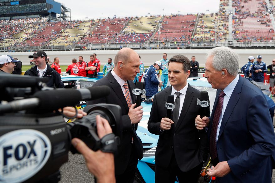 FILE - In this June 9, 2019, file photo, Fox Sports broadcasters Adam Alexander, left, Jeff Gordon, center, and Darrell Waltrip are shown on pit row before the NASCAR cup series auto race at Michigan International Speedway in Brooklyn, Mich. NASCAR will have a much different feel when it resumes this weekend as the two-man broadcast team for Fox will not travel to Darlington Raceway and instead call the race from a studio in Charlotte.(AP Photo/Carlos Osorio, FIle)