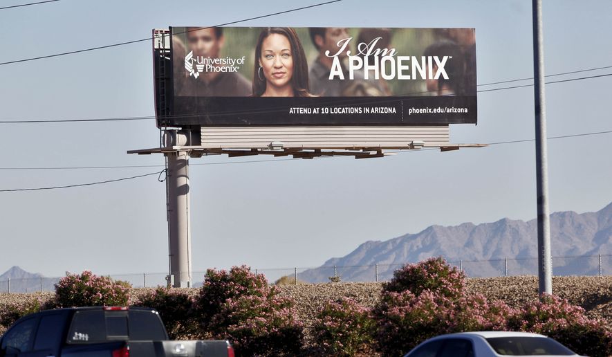 FILE - In this Nov 24, 2009 file photo, a University of Phoenix billboard is shown in Chandler, Ariz. Some of the nation’s largest for-profit colleges are ramping up advertising, hiring recruiters and offering discounts for online classes as they predict that the coronavirus will steer more Americans back to school, helping revive the industry. (AP Photo/Matt York, File) **FILE**