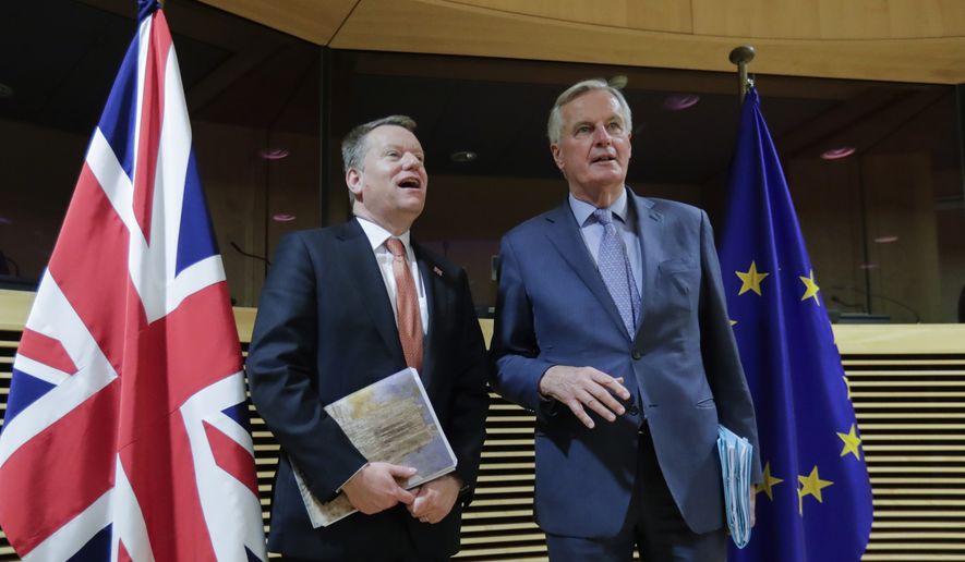 In this Monday, March 2, 2020, photo, European Commission&#x27;s Head of Task Force for Relations with the United Kingdom Michel Barnier, right, speaks with the British Prime Minister&#x27;s Europe adviser David Frost during the start of the first round of post -Brexit trade talks between the EU and the UK, at EU headquarters in Brussels. (Olivier Hoslet, Pool Photo via AP) **FILE**