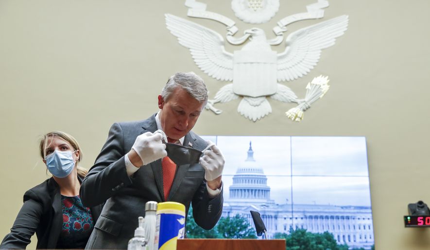 Richard Bright, former director of the Biomedical Advanced Research and Development Authority, arrives for a House Energy and Commerce Subcommittee on Health hearing to discuss protecting scientific integrity in response to the coronavirus outbreak, Thursday, May 14, 2020 on Capitol Hill in Washington.  (Shawn Thew/Pool via AP)