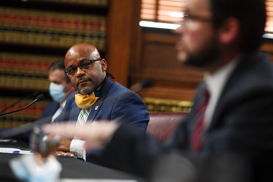 Mayor Michael Hancock listens as chief financial officer Brendan Hanlon speaks during a briefing in Denver on Thursday, May 14, 2020, on the state of the Denver's budget, city employee furloughs and the resumption of business after closures due to the coronavirus. (AAron Ontiveroz/The Denver Post via AP)