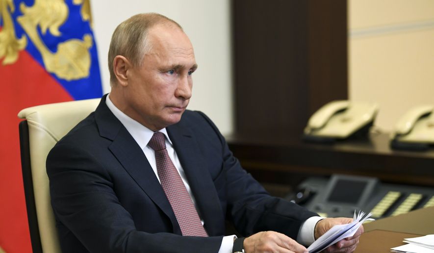 Russian President Vladimir Putin takes part in a video conference on the opening of medical facilities for COVID-19 patients built by the military across the country in the Novo-Ogaryovo residence outside Moscow, Russia, Friday, May 15, 2020. The Russian Defense Ministry built 16 hospitals with a total capacity of 1,600 patients.(Alexei Nikolsky, Sputnik, Kremlin Pool Photo via AP) **FILE**