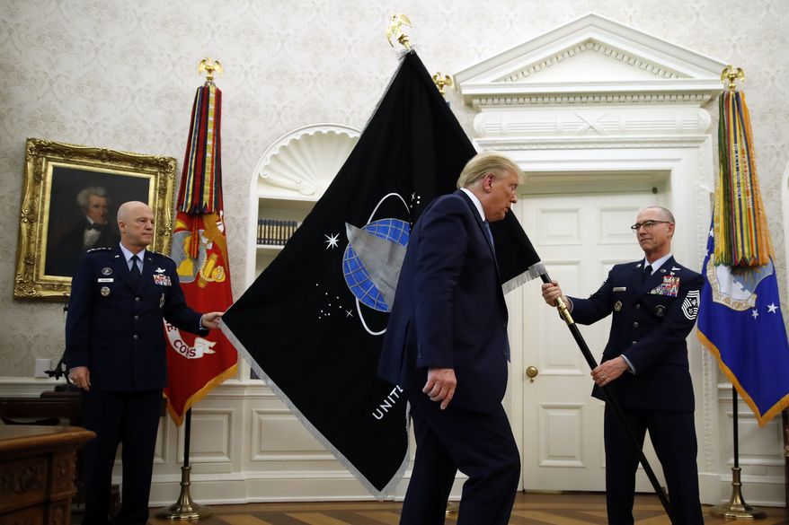Chief of Space Operations at U.S. Space Force Gen. John Raymond, left, and Chief Master Sgt. Roger Towberman, right, hold the United States Space Force flag&amp;#160;as President Donald Trump walks past it in the Oval Office of the White House, Friday, May 15, 2020, in Washington. (AP Photo/Alex Brandon) ** FILE **