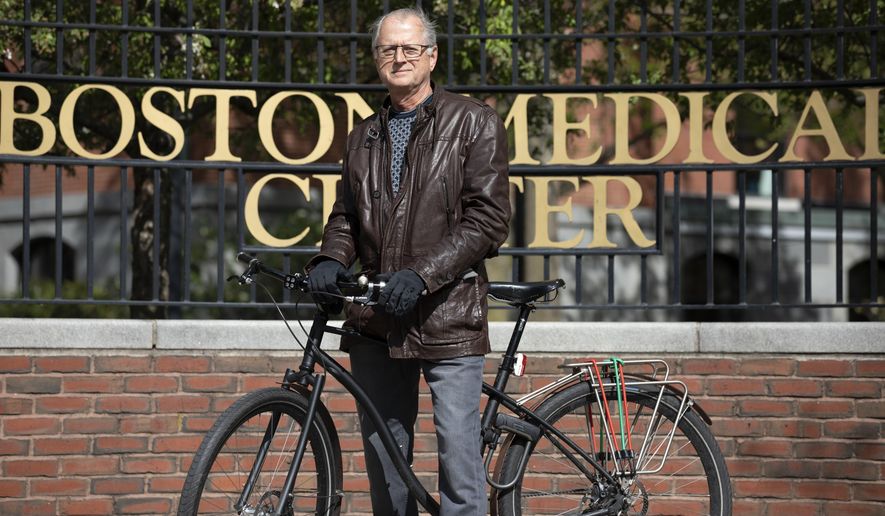 In this Saturday, May 9, 2020, photo, attorney Clyde Bergstresser poses outside Boston Medical Center in Boston. During a storied legal career, Bergstresser has become one of the go-to medical malpractice lawyers in Massachusetts. But as COVID-19 cases surged at Boston area hospitals, Bergstresser found his sympathies aligning with the professions he has often fingered in million-dollar lawsuits. (AP Photo/Michael Dwyer)