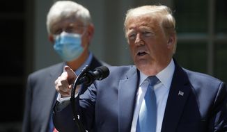 President Donald Trump speaks about the coronavirus in the Rose Garden of the White House, Friday, May 15, 2020, in Washington. Dr. Robert Redfield, director of the Centers for Disease Control and Prevention listens at left. (AP Photo/Alex Brandon)
