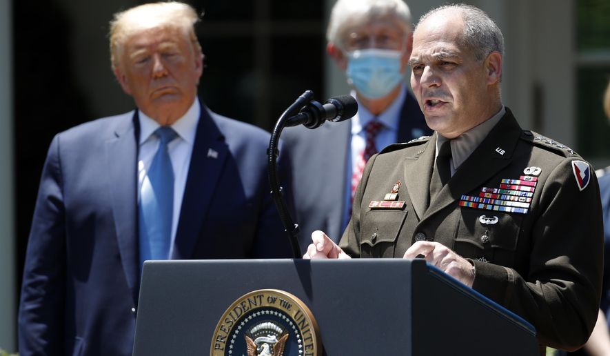President Donald Trump listens as Gen. Gustave Perna speaks about the coronavirus in the Rose Garden of the White House, Friday, May 15, 2020, in Washington. (AP Photo/Alex Brandon)