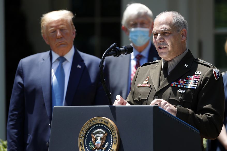 President Donald Trump listens as Gen. Gustave Perna speaks about the coronavirus in the Rose Garden of the White House, Friday, May 15, 2020, in Washington. (AP Photo/Alex Brandon)