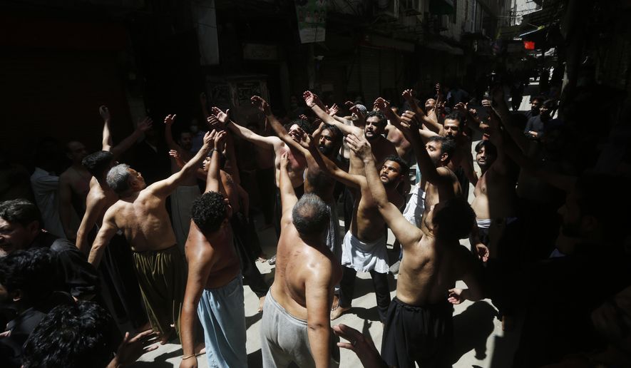 Pakistani Shiite Muslims gather to beat themselves during a procession commemorating the death anniversary of Imam Ali, the son-in-law and cousin of the Prophet Muhammad and the first Imam of the Muslim Shiites, in Lahore, Pakistan, Friday, May 15, 2020. (AP Photo/K.M. Chaudary)