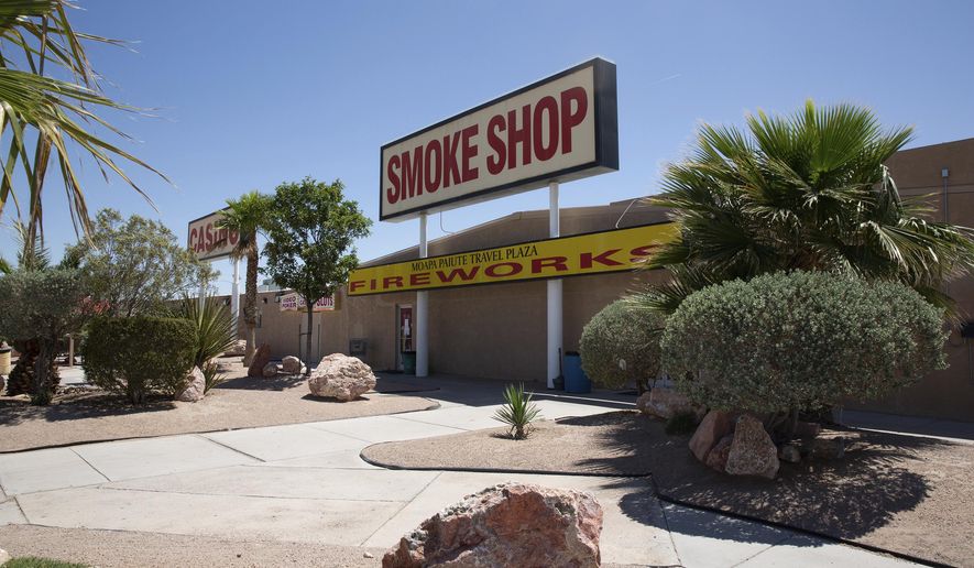 This May 13, 2020 photo shows the Moapa Paiute Travel Plaza located 55 miles northeast of downtown Las Vegas. Since the coronavirus prompted widespread casino and business closures in Nevada in March, the Moapa Band of Paiutes has prioritized protecting tribe members, particularly elders. The tribal casino closed in mid-March, leaving the primary remaining source of tribal revenue the Moapa Paiute Travel Plaza truck stop, gas station and convenience store on Interstate 15 near Valley of Fire State Park. (Christopher DeVargas/Las Vegas Sun via AP)
