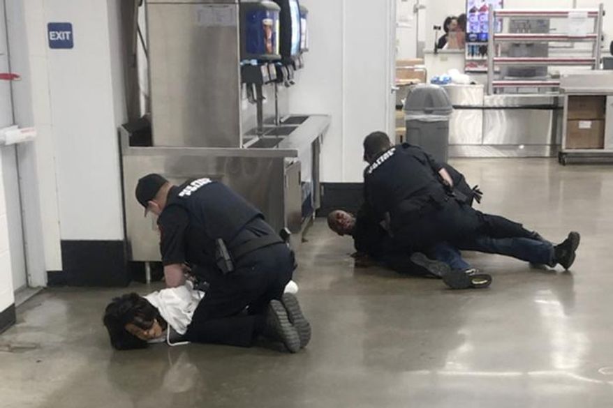 In this March 23, 2020 frame grab taken from video, Marvia Gray, left and her son Derek Gray are arrested at a Sam's Club store in Des Peres, Missouri. A lawsuit filed Monday May 18, 2020, accuses four white suburban St. Louis police officers of brutalizing Gray and her adult son after wrongly accusing them of stealing a television. Gray alleges she suffered serious and permanent injuries during her arrest. Her 43-year-old son, Derek, suffered a concussion, three shattered teeth and other injuries, according to the lawsuit.(Photo courtesy Action Injury Law Group via AP)