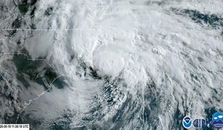 In this satellite image made available by NOAA shows Tropical Storm Arthur off the coast of North Carolina, Monday, May 18, 2020. The storm dropped several inches of rain on parts of eastern North Carolina and flooded roads before moving out to sea away from the state. (NOAA via AP)