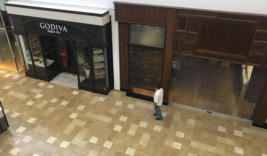 After being closed for several weeks due to the coronavirus outbreak, Chandler Fashion Center Mall welcomes back patrons Sunday, May 17, 2020, in Chandler, Ariz. While the mall was open, many of the chain stores remained closed. (AP Photo/Ross D. Franklin)