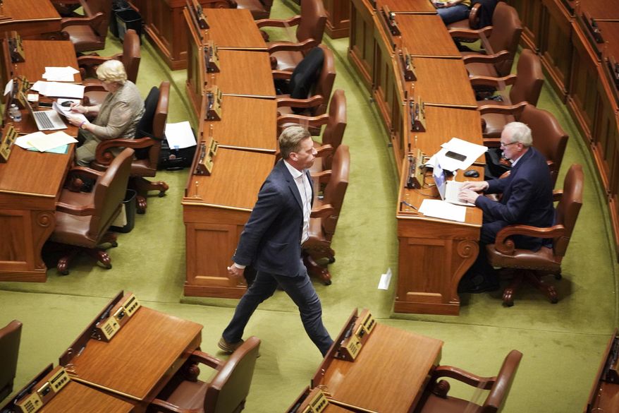 House Minority Leader Kurt Daudt, R-Crown walks out of the House Chamber Sunday, May 17, 2020 not wearing a mask, in St. Paul. All the DFL legislators choose to wear a mask on the House floor and all the Republican legislators choose not to wear masks on the floor. (Glen Stubbe/Star Tribune via AP)