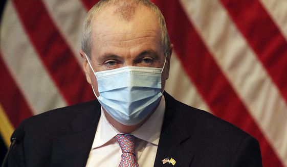 New Jersey Gov. Phil Murphy wears a mask during his daily coronavirus news conference at the War Memorial, Tuesday, May 19, 2020, in Trenton, N.J. (Chris Pedota/The Record via AP, Pool)