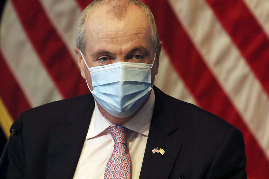 New Jersey Gov. Phil Murphy wears a mask during his daily coronavirus news conference at the War Memorial, Tuesday, May 19, 2020, in Trenton, N.J. (Chris Pedota/The Record via AP, Pool)