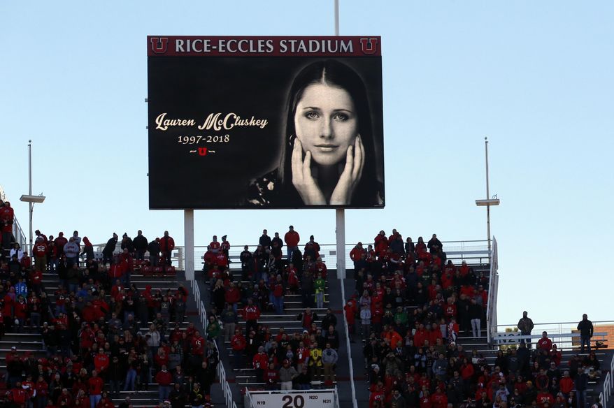 FILE - In this Nov. 10, 2018, file photo, a photograph of University of Utah student and track athlete Lauren McCluskey, who was fatally shot on campus, is projected on the video board before the start of an NCAA college football game between Oregon and Utah in Salt Lake City. The parents of a University of Utah student killed on campus by an ex-boyfriend said Monday they feel a fresh sense of betrayal after new allegations surfaced that a police officer investigating her report kept explicit photos that were intended as evidence. (AP Photo/Rick Bowmer, File)