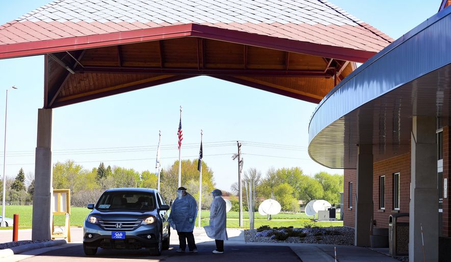 A car pulls up to the screening station on Thursday, May 14, at the Flandreau Santee Sioux Tribal Health Center in South Dakota. (Erin Bormett/The Argus Leader via AP)