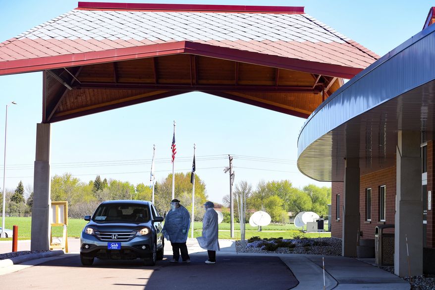 A car pulls up to the screening station on Thursday, May 14, at the Flandreau Santee Sioux Tribal Health Center in South Dakota. (Erin Bormett/The Argus Leader via AP)