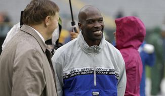 FILE - In this Sept. 22, 2019, file photo, former NFL football player player Chad Johnson, right, talks with Green Bay Packers president and chief executive officer Mark Murphy before the start of a game between the Denver Broncos and Green Bay Packers in Green Bay, Wis. Chad Johnson left a whooping $1,000 tip for his waiter after dining at a restaurant in Florida that recently reopened amid the coronavirus outbreak. “Congrats on re-opening, sorry about the pandemic, hope this helps. I LOVE YOU,” Johnson wrote Monday, May 18, 2020, on his $37 tab. (AP Photo/Mike Roemer, File)