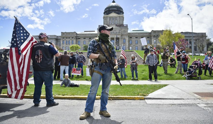 Protesters gather outside the Montana State Capitol in Helena, Mont., Wednesday, May 20, 2020 criticizing Gov. Steve Bullock's response to the COVID-19 pandemic. (Thom Bridge/Independent Record via AP)