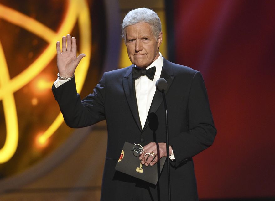FILE - This May 5, 2019 file photo shows Alex Trebek presenting an award at the 46th annual Daytime Emmy Awards in Pasadena, Calif. The “Jeopardy!” veteran host's nomination for best game show host could give him for a second consecutive win in the category. (Photo by Chris Pizzello/Invision/AP, File)