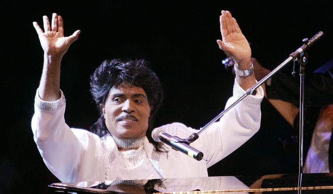 FILE - In this Aug. 19, 2004 file photo, Little Richard performs at Westbury Music Fair in Westbury, NY.  Little Richard, the self-proclaimed “architect of rock ‘n’ roll” whose piercing wail, pounding piano and towering pompadour irrevocably altered popular music while introducing black R&amp;amp;B to white America, has died Saturday, May 9, 2020. (AP Photo/Ed Betz, File)