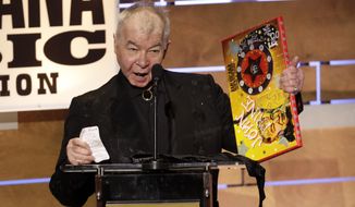 FILE - This Sept. 11, 2019 file photo shows John Prine accepting the Album of the Year award at the Americana Honors &amp;amp; Awards show in Nashville, Tenn. The Recording Academy has released a new recording of John Prine’s “Angel From Montgomery” with proceeds going to support the MusiCares COVID-19 Relief Fund. Prine died in April at age 73 from complications associated with the new coronavirus. (AP Photo/Wade Payne, File)