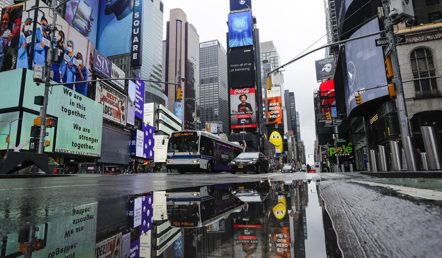 Vehicles move through a nearly empty Times Square during the coronavirus pandemic, Saturday, May 23, 2020, in New York. (AP Photo/Frank Franklin II)