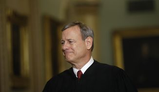 FILE - In this Jan. 16, 2020, file photo Chief Justice of the United States, John Roberts walks to the Senate chamber at the Capitol in Washington. Roberts told graduating seniors at his son&#39;s high school that the coronavirus has “pierced our illusion of certainty and control&amp;quot; and counseled them to make their way in a world turned upside down with humility, compassion and courage. (AP Photo/Matt Rourke, File)